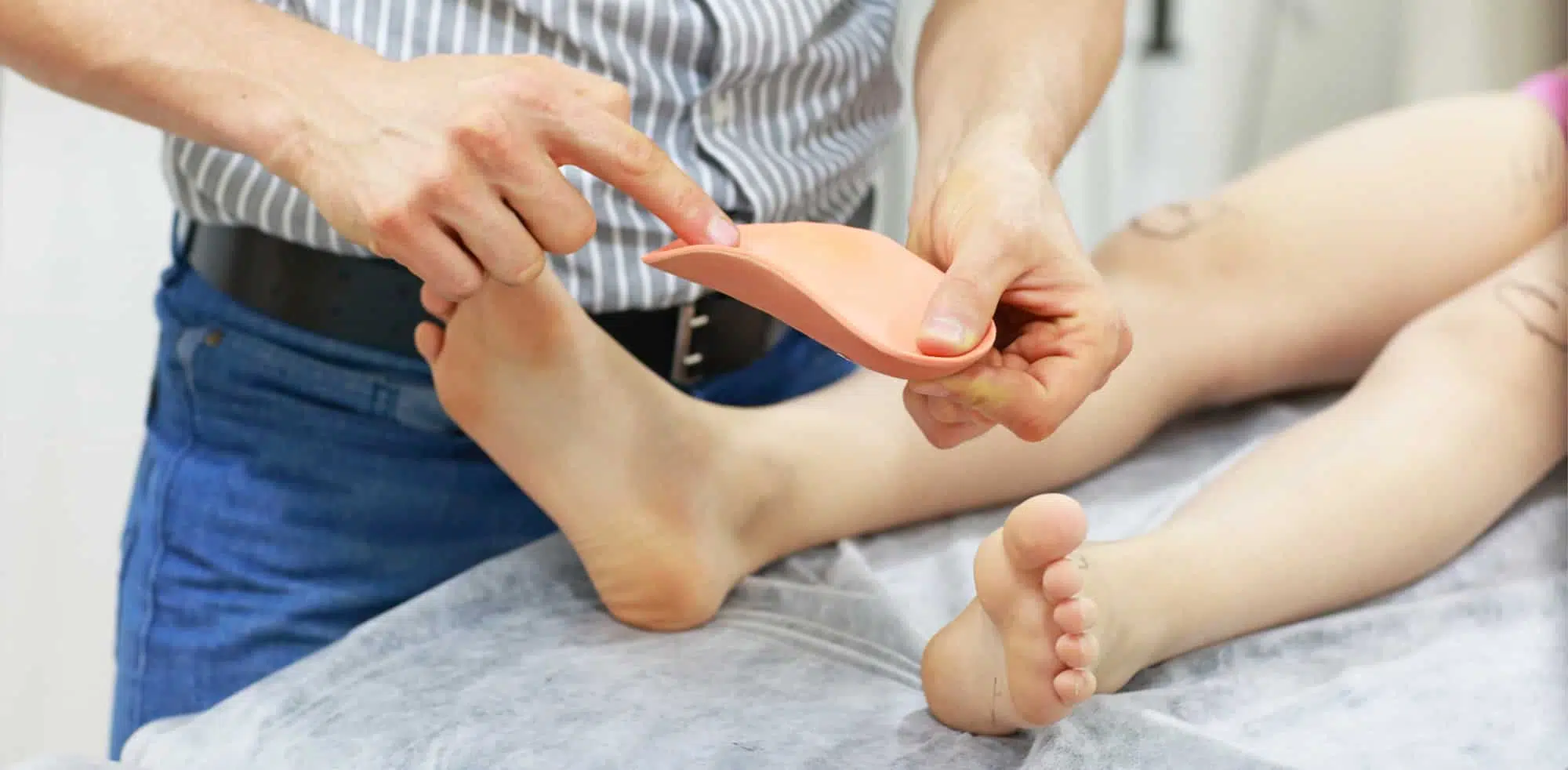 Podiatrist explaining orthotic to patient